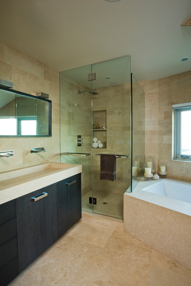 Contemporary master bathroom in Orange County with flat-panel cabinets, black cabinets, an undermount tub, a corner shower, beige walls, limestone floors and a trough sink.