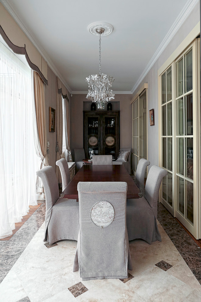 This is an example of a transitional separate dining room in Moscow with pink walls and marble floors.