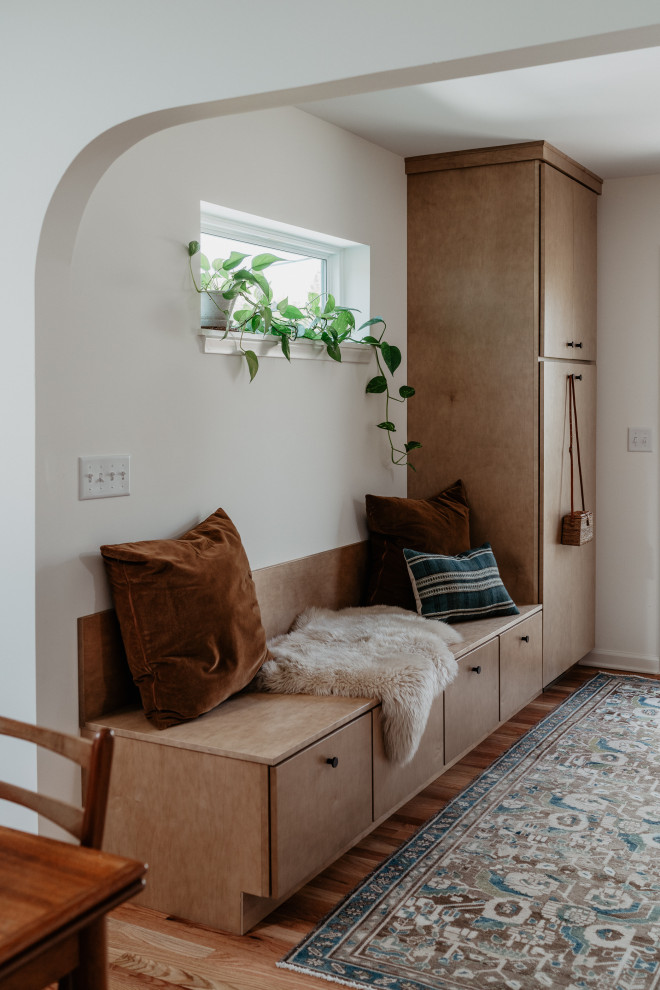 Mid-sized mid-century modern l-shaped medium tone wood floor kitchen pantry photo in Detroit with an undermount sink, flat-panel cabinets, light wood cabinets, quartz countertops, white backsplash, quartz backsplash, stainless steel appliances, a peninsula and white countertops