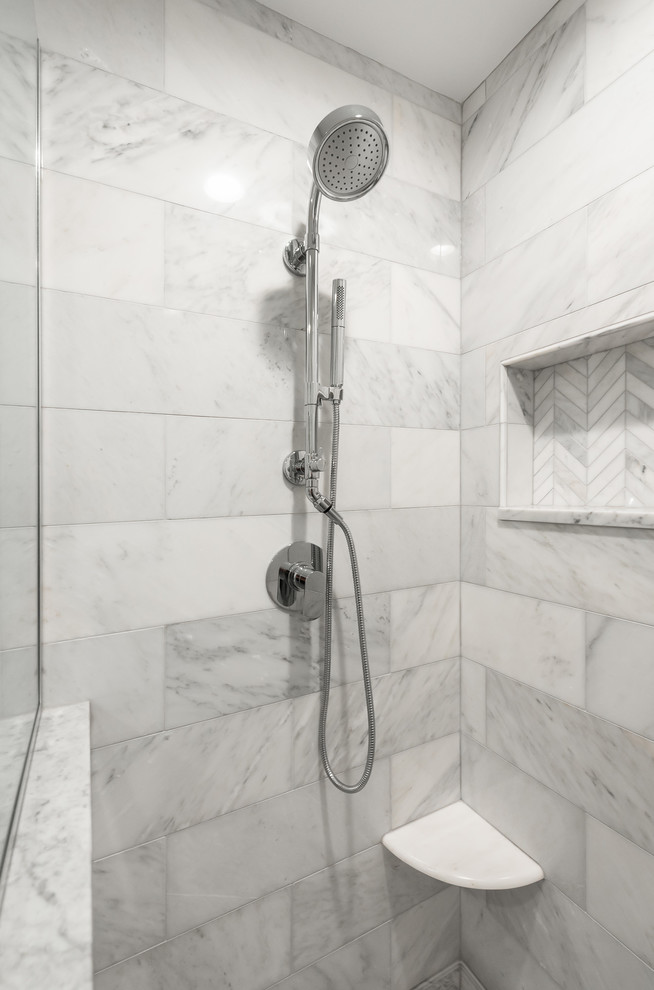 This is an example of a mid-sized transitional master bathroom in Chicago with recessed-panel cabinets, grey cabinets, an alcove shower, a two-piece toilet, gray tile, marble, white walls, marble floors, an undermount sink, marble benchtops, grey floor, a hinged shower door and white benchtops.