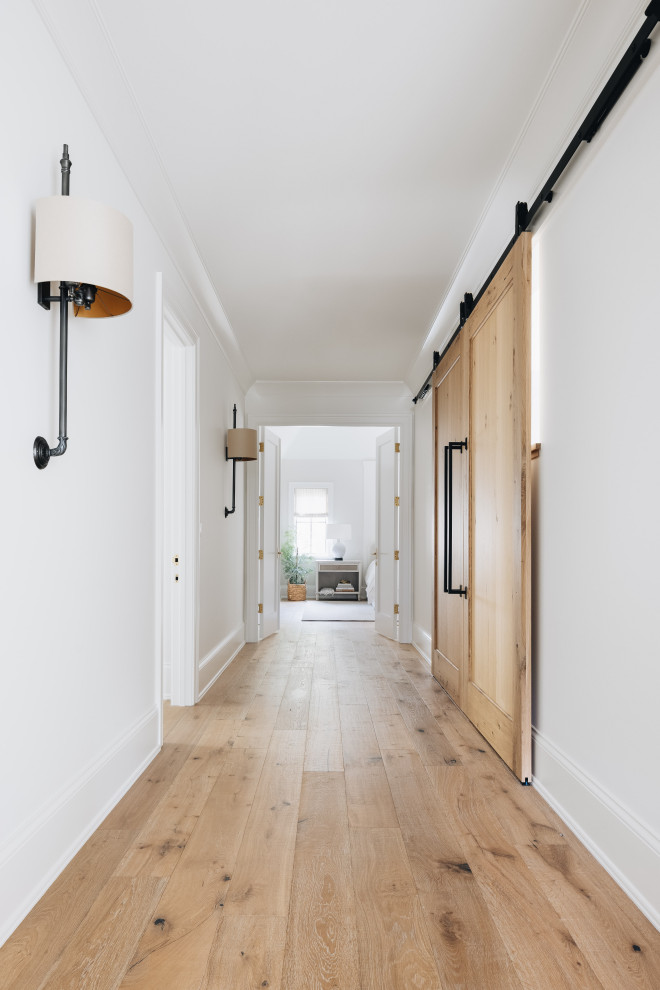 ASC Margaritaville - Large transitional light wood floor and brown floor hallway photo in Chicago with white walls