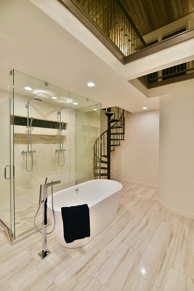 Large modern master bathroom in Salt Lake City with a freestanding tub, a double shower, white tile, limestone, white walls, marble floors, white floor and a hinged shower door.