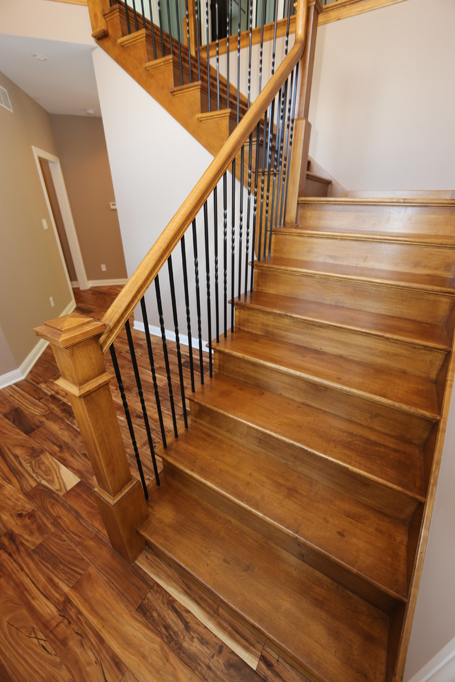 Large traditional wood l-shaped staircase in Chicago with wood risers.