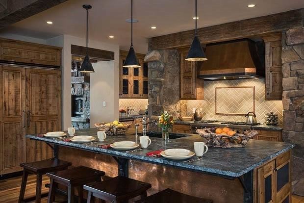 Open concept kitchen - mid-sized rustic u-shaped dark wood floor and brown floor open concept kitchen idea in Orange County with an undermount sink, raised-panel cabinets, dark wood cabinets, granite countertops, beige backsplash, stone tile backsplash, stainless steel appliances and an island