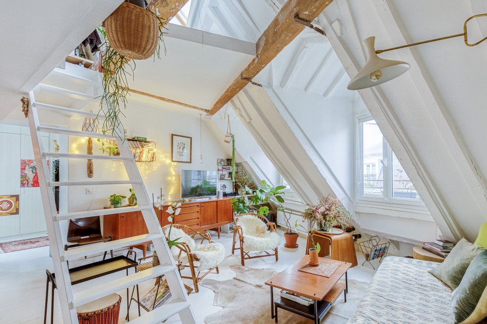 Photo of an eclectic open concept living room in Paris with white walls, a freestanding tv, white floor and vaulted.