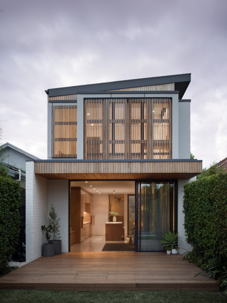 Contemporary two-storey white house exterior in Sydney with a shed roof.