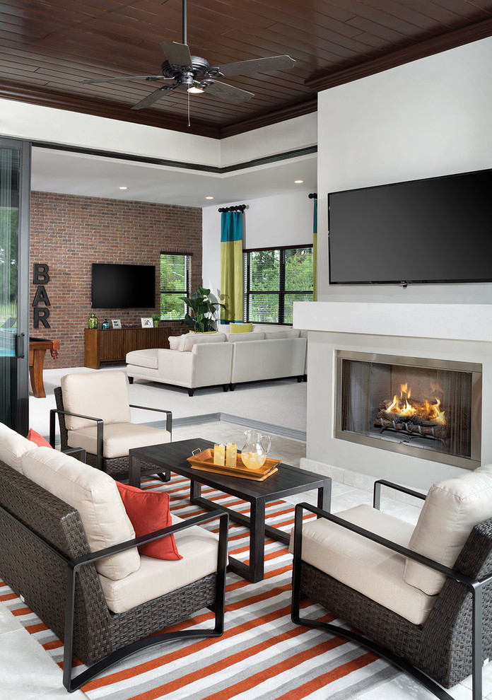 Inspiration for a mid-sized contemporary open concept living room in Orlando with grey walls, a standard fireplace, a metal fireplace surround, a wall-mounted tv and marble floors.