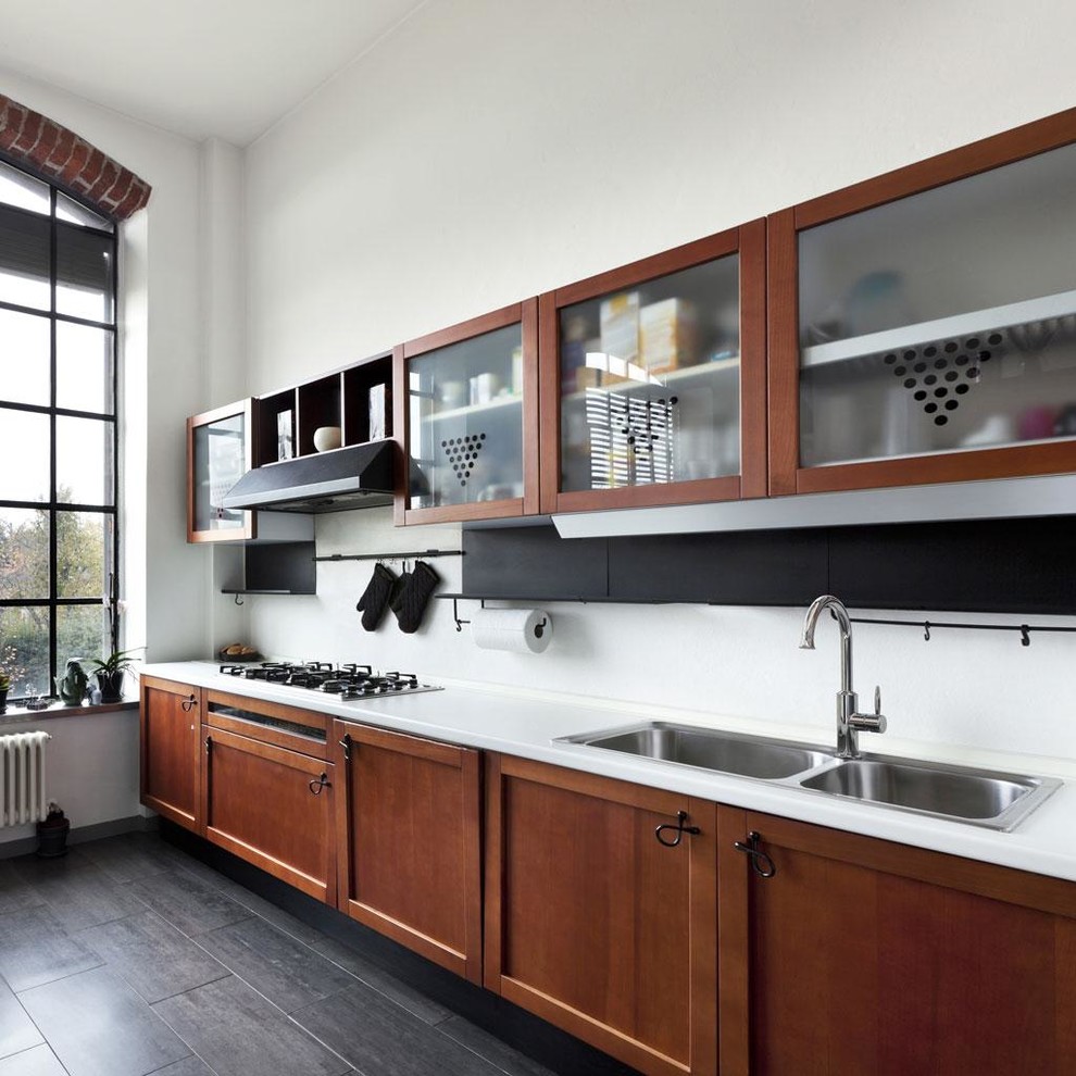 Photo of a contemporary single-wall kitchen in Stuttgart with glass-front cabinets, medium wood cabinets, a double-bowl sink, dark hardwood floors and white splashback.