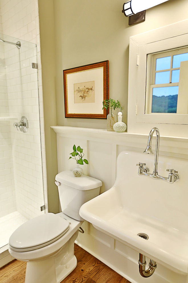 Photo of a large country 3/4 bathroom in Nashville with flat-panel cabinets, dark wood cabinets, a two-piece toilet, beige walls, vinyl floors, a wall-mount sink, quartzite benchtops, an alcove shower, white tile and subway tile.