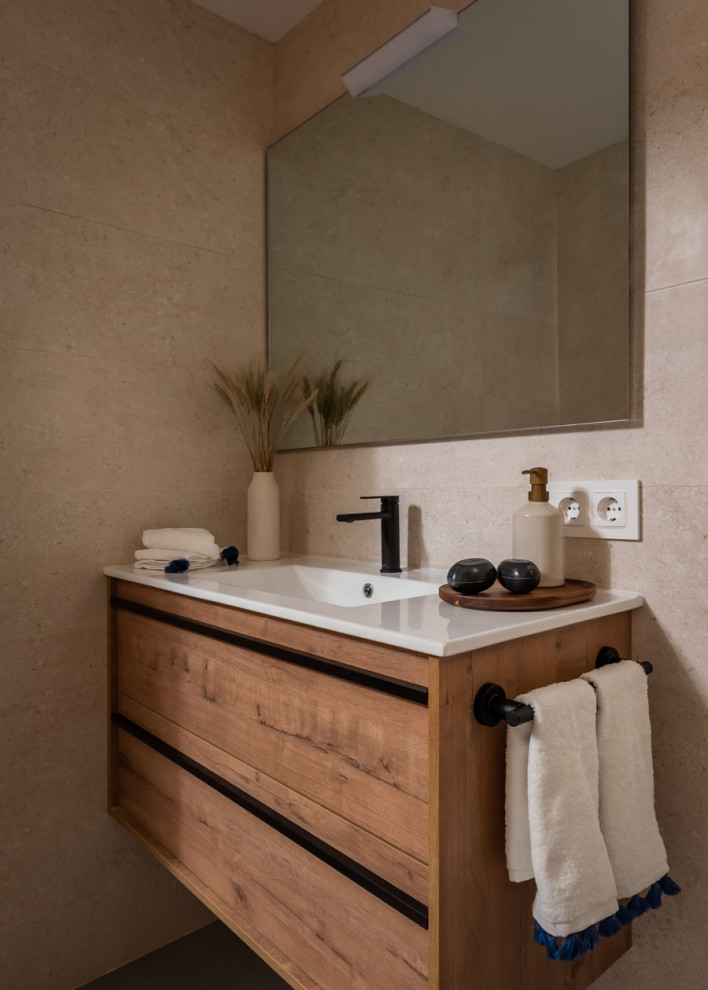 This is an example of a mid-sized mediterranean master bathroom in Barcelona with an open shower, beige tile, ceramic tile, porcelain floors and a floating vanity.