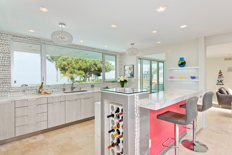 Design ideas for a mid-sized contemporary l-shaped open plan kitchen in San Diego with an undermount sink, flat-panel cabinets, grey cabinets, a peninsula, stainless steel appliances, travertine floors, multi-coloured splashback, mosaic tile splashback, solid surface benchtops, beige floor and white benchtop.