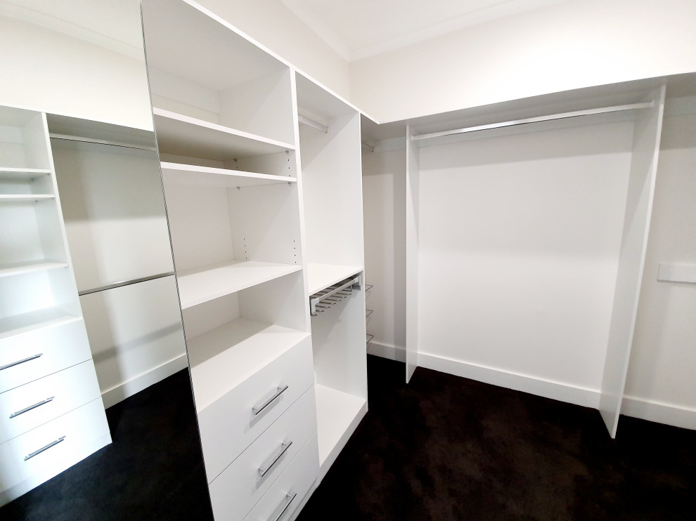 Mid-sized contemporary walk-in wardrobe in Melbourne with carpet and grey floor.