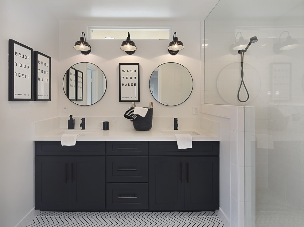 Inspiration for a mid-sized modern kids bathroom in Orange County with shaker cabinets, black cabinets, an open shower, a one-piece toilet, white tile, subway tile, white walls, porcelain floors, a drop-in sink, engineered quartz benchtops, white floor, an open shower and white benchtops.