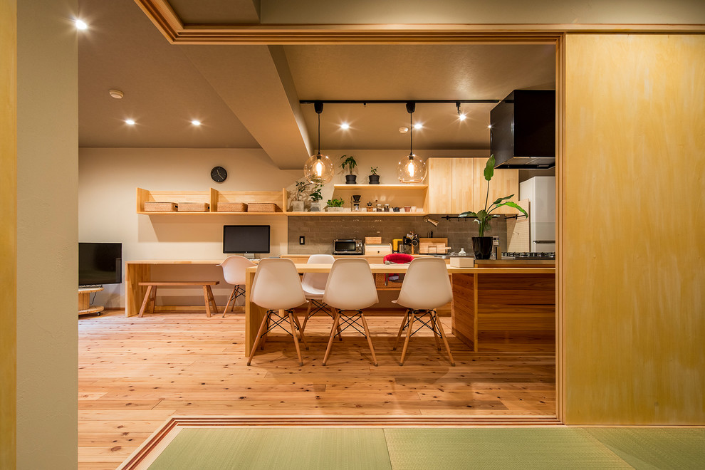 Design ideas for an asian open plan dining in Tokyo with white walls, medium hardwood floors and brown floor.