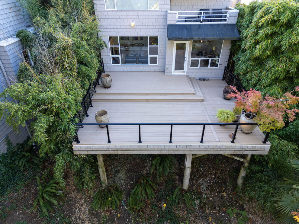 Example of a mid-sized backyard second story cable railing deck design in Seattle