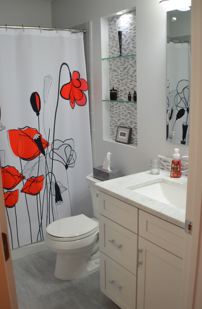 Inspiration for a transitional gray tile bathroom remodel with shaker cabinets, white cabinets and marble countertops