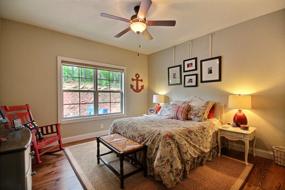Inspiration for a country bedroom in Atlanta with beige walls and medium hardwood floors.
