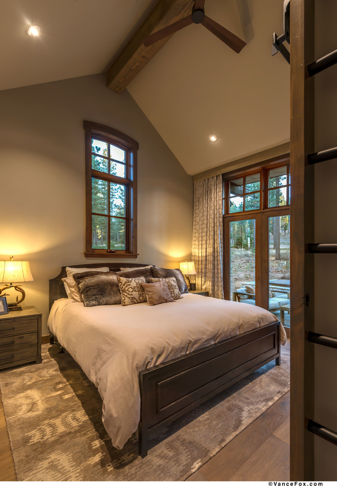 Landhaus Hauptschlafzimmer mit grauer Wandfarbe und braunem Holzboden in Sonstige