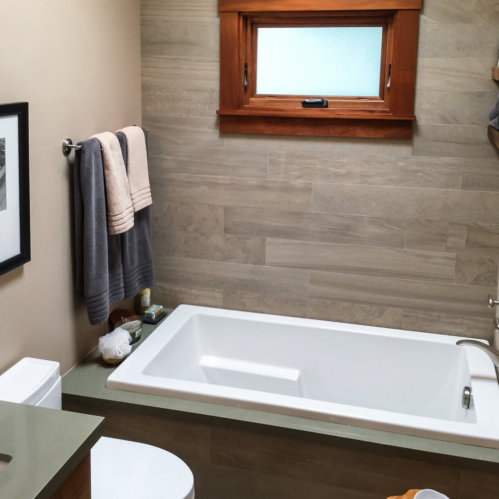 Inspiration for a mid-sized transitional master gray tile and porcelain tile cement tile floor and gray floor drop-in bathtub remodel with recessed-panel cabinets, dark wood cabinets, beige walls, an undermount sink, quartz countertops and a hinged shower door