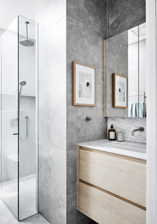 Contemporary Elegance: Gray Wall Tiles and Wood Flat-Panel Cabinetry for a Sophisticated Bathroom Vanity
