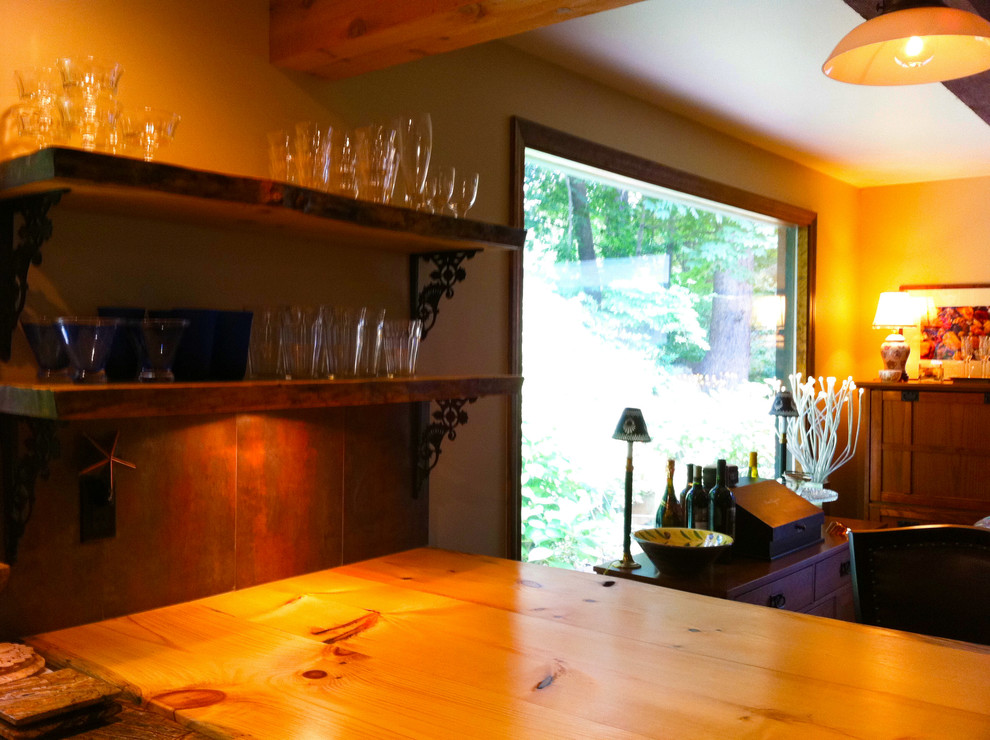 Kitchen - mid-sized rustic kitchen idea with medium tone wood cabinets, wood countertops, metallic backsplash and an island