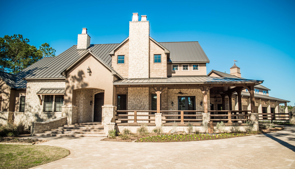 Inspiration for a large rustic beige two-story stone exterior home remodel