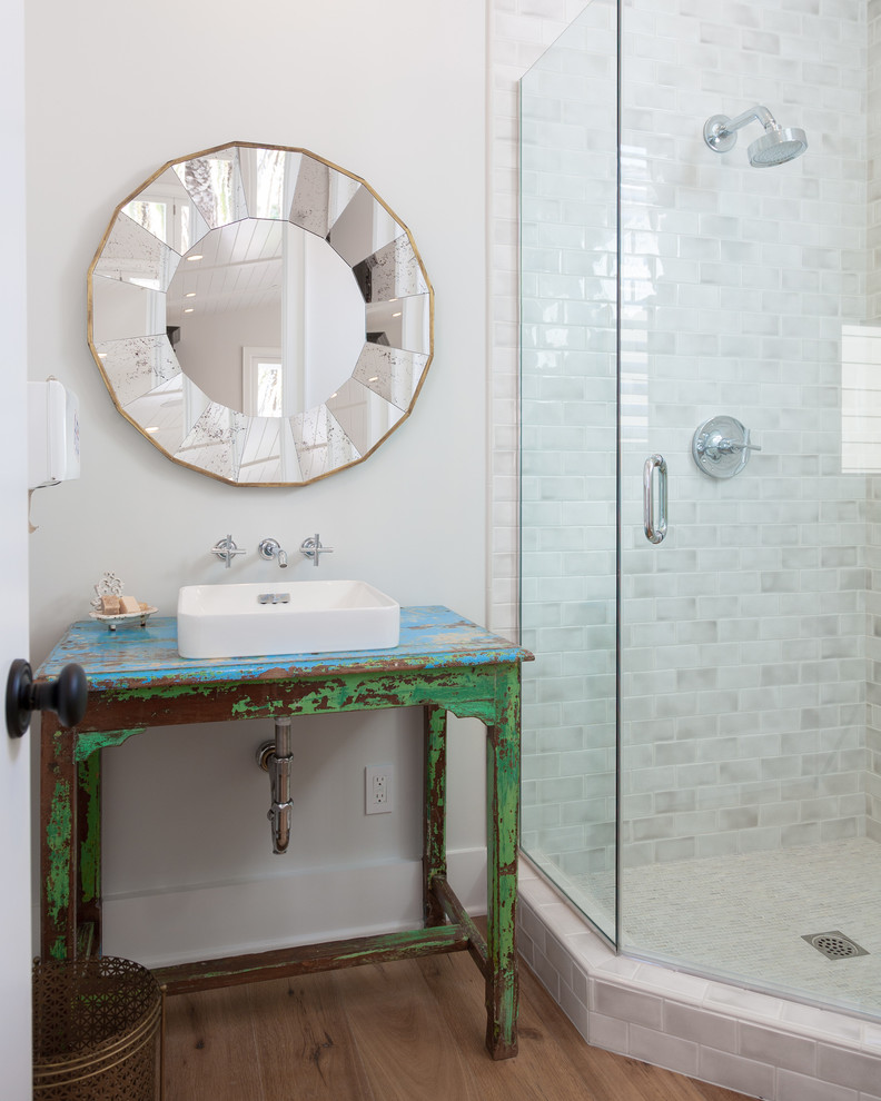 Photo of a beach style bathroom in Orange County with a vessel sink, distressed cabinets, a corner shower, white tile, subway tile and open cabinets.