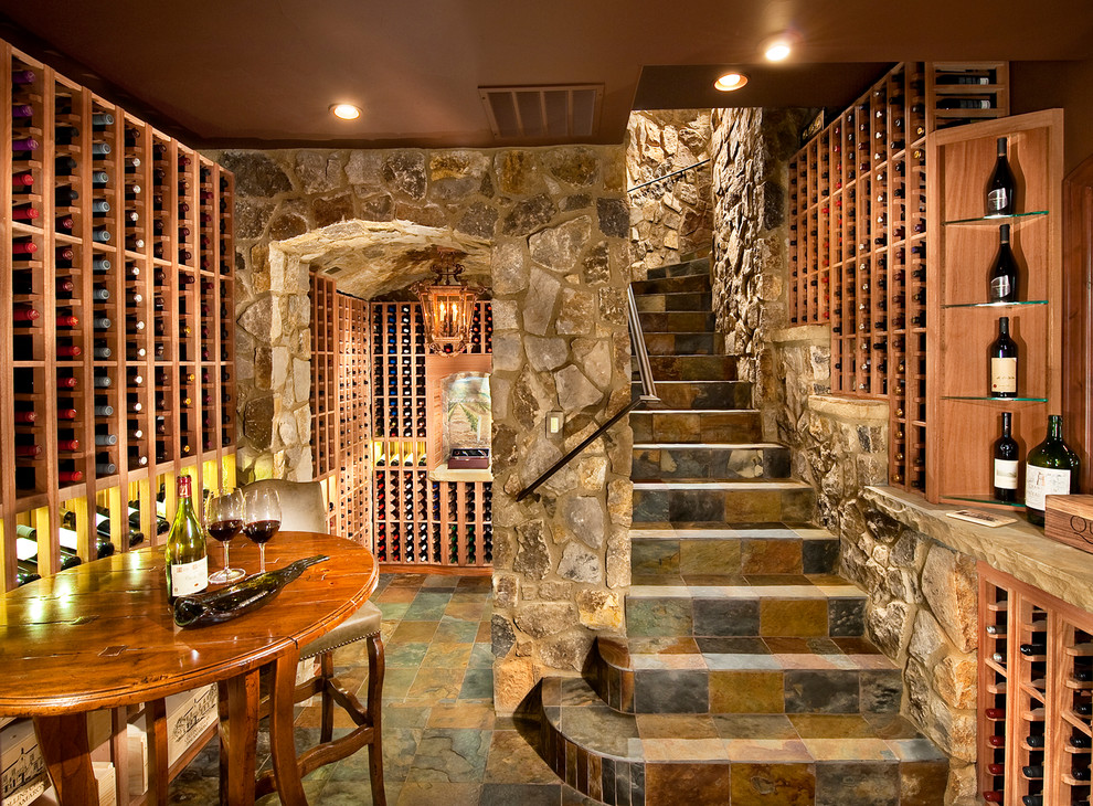 This is an example of a large traditional wine cellar in Denver with storage racks, slate floors and multi-coloured floor.