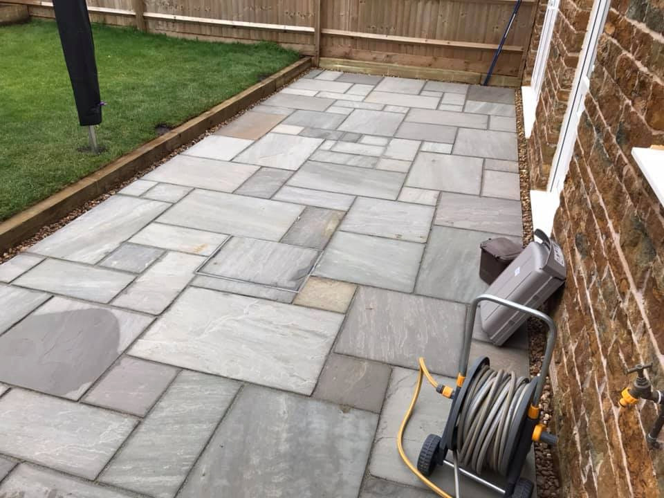 Photo of a small midcentury backyard full sun xeriscape for summer in Oxfordshire with with raised garden bed and natural stone pavers.