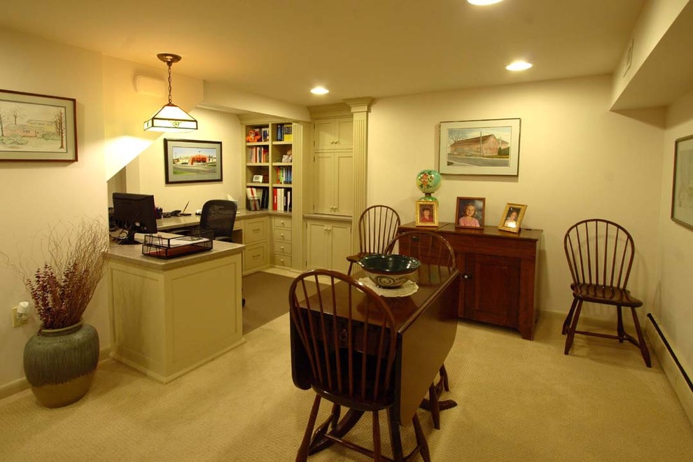 This is an example of a mid-sized traditional home office in Philadelphia with white walls and carpet.
