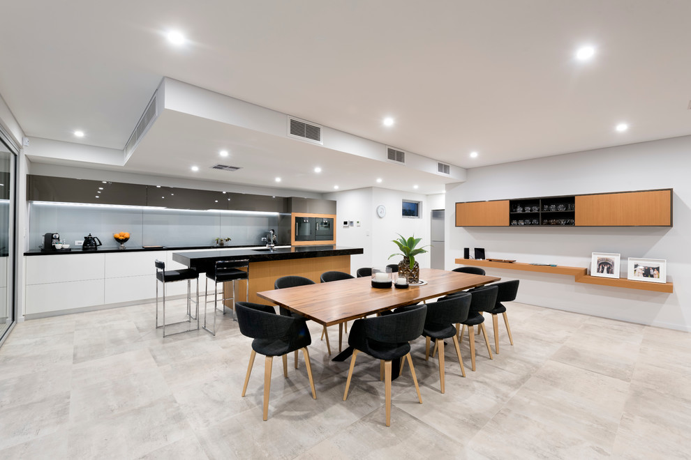 Inspiration for a large contemporary galley open plan kitchen in Perth with an undermount sink, flat-panel cabinets, medium wood cabinets, quartz benchtops, grey splashback, glass sheet splashback, black appliances, porcelain floors and with island.
