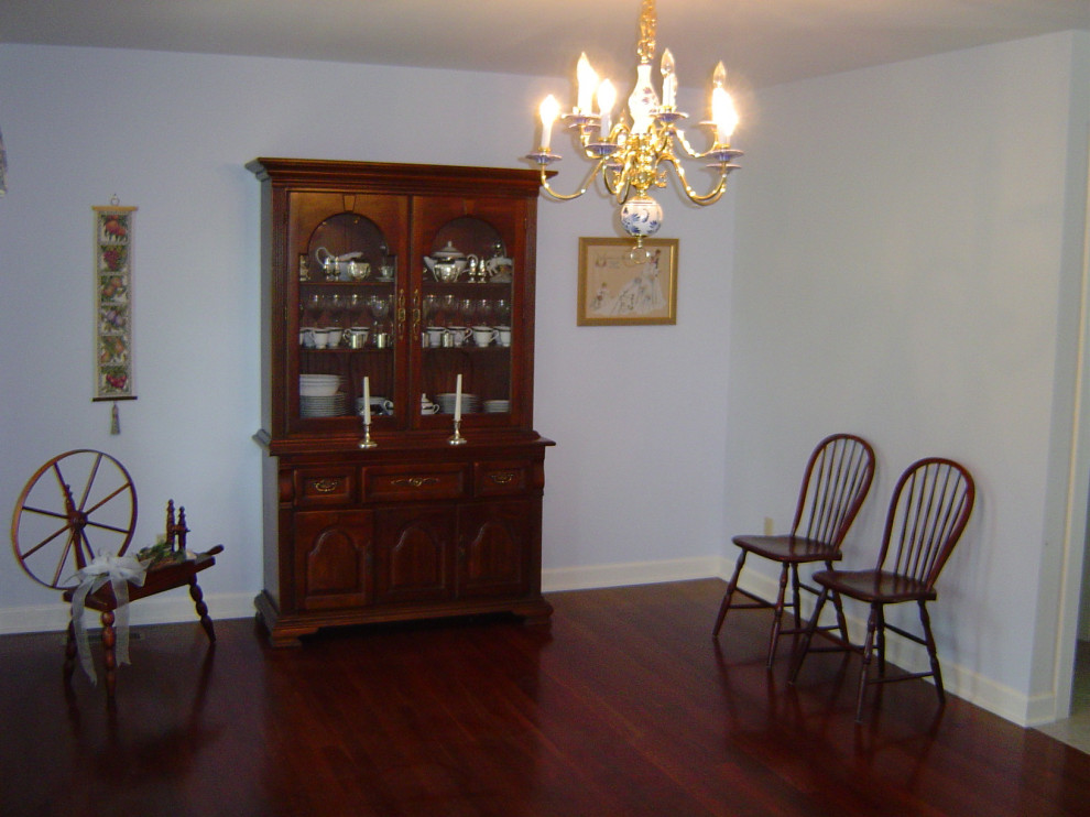 Dining room - mid-sized dark wood floor dining room idea with blue walls
