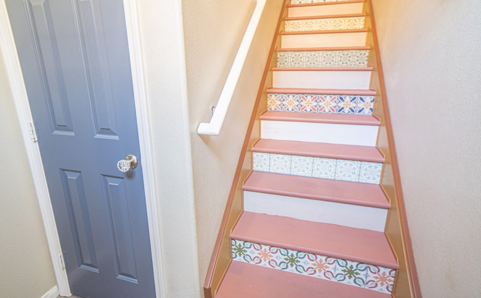 Ejemplo de escalera recta bohemia con escalones de madera pintada, contrahuellas de madera pintada y barandilla de madera