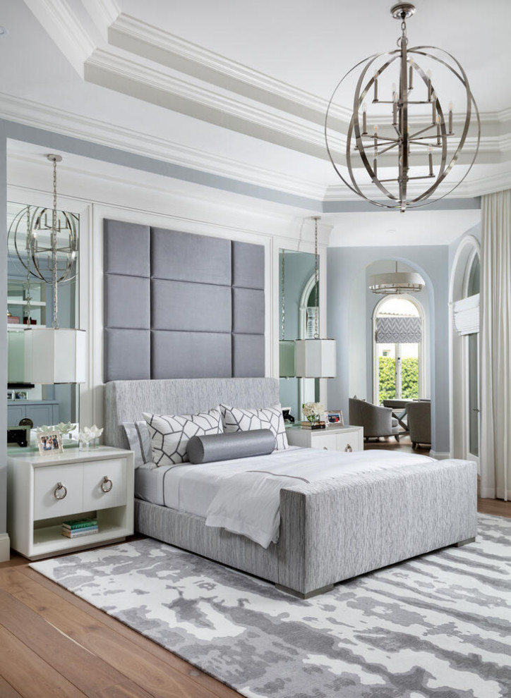 На фото: огромная хозяйская спальня в стиле неоклассика (современная классика) с серыми стенами, паркетным полом среднего тона, коричневым полом и деревянными стенами с