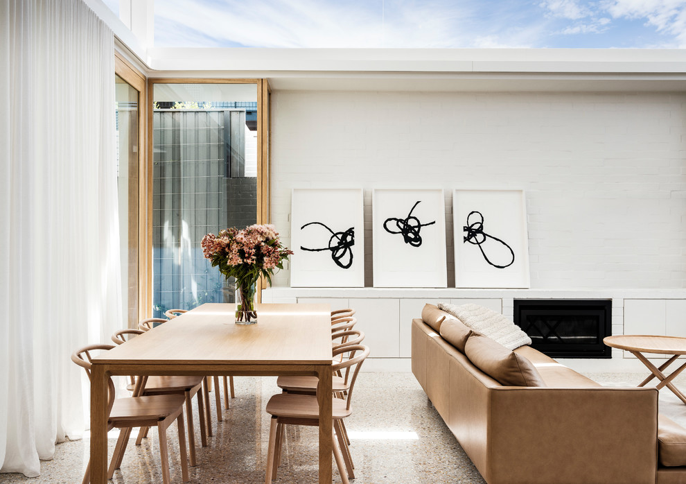 This is an example of a contemporary open plan dining in Sydney with white walls.