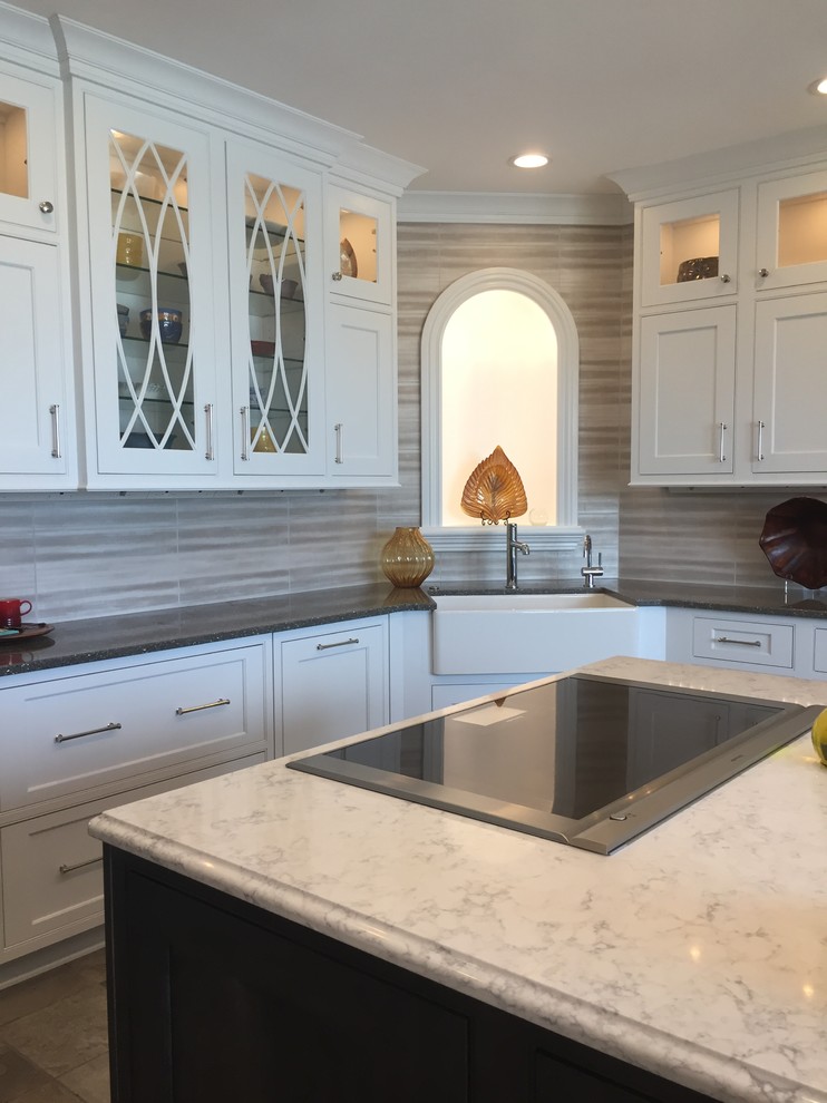 Large transitional ceramic tile and multicolored floor kitchen photo with a farmhouse sink, beaded inset cabinets, white cabinets, quartz countertops, metallic backsplash, ceramic backsplash, stainless steel appliances and an island