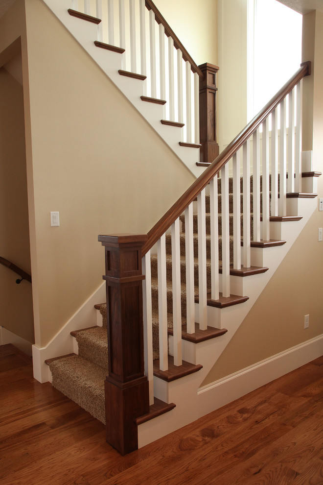 Inspiration for a mid-sized traditional carpeted u-shaped staircase in Salt Lake City with carpet risers.