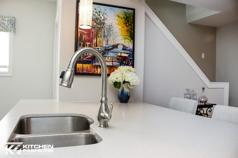 Mid-sized transitional single-wall ceramic tile open concept kitchen photo with an undermount sink, shaker cabinets, gray cabinets, solid surface countertops, gray backsplash, mosaic tile backsplash, white appliances and an island