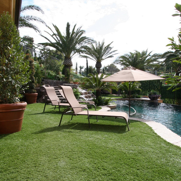 Large tuscan backyard stamped concrete and custom-shaped natural pool landscaping photo in Salt Lake City