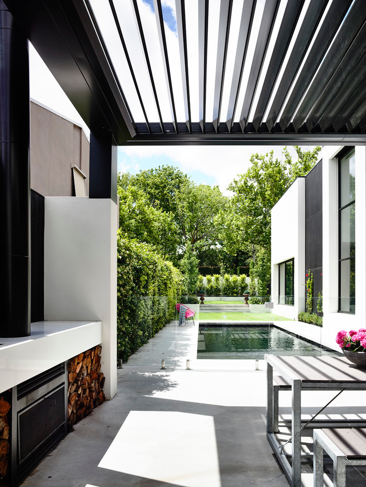 Inspiration for a modern backyard rectangular lap pool in Melbourne with a hot tub and concrete pavers.