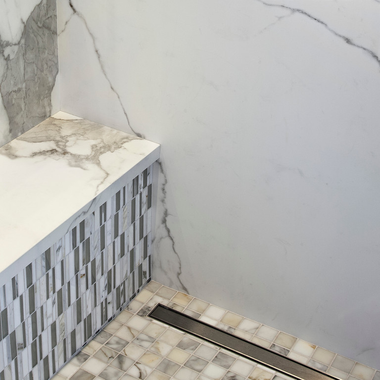 Inspiration for a mid-sized contemporary 3/4 bathroom in San Francisco with a pedestal sink, white cabinets, a curbless shower, white tile, porcelain tile, white walls and porcelain floors.
