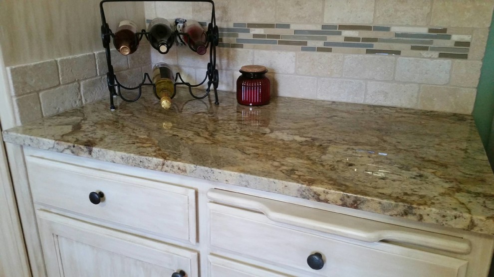 Mid-sized transitional u-shaped eat-in kitchen photo in Seattle with an undermount sink, recessed-panel cabinets, distressed cabinets, granite countertops, beige backsplash, stone tile backsplash, white appliances and a peninsula