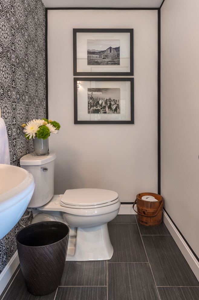 This is an example of a small traditional powder room in Boston with white cabinets, a one-piece toilet, black and white tile, white walls, dark hardwood floors, a console sink, brown floor, a floating vanity and decorative wall panelling.