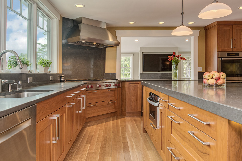 Kitchen - transitional u-shaped medium tone wood floor kitchen idea in Boston with an undermount sink, shaker cabinets, medium tone wood cabinets, quartz countertops, gray backsplash, stone slab backsplash, stainless steel appliances and an island