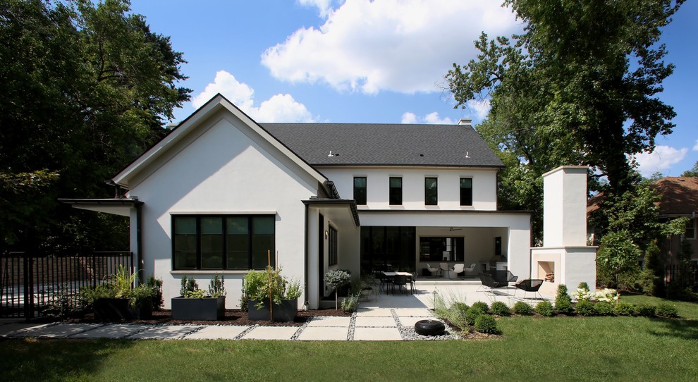 Large transitional two-storey stucco white house exterior in Kansas City with a gable roof and a shingle roof.