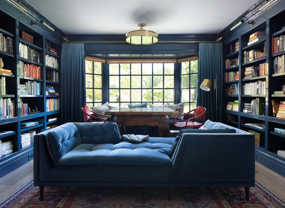 Comfortable and Collected - The family living in this shingled roofed home on the Peninsula loves color and pattern. At the heart of the two-story house, we created a library with high gloss lapis blue walls. The tête-à-tête provides an inviting place for the couple to read while their children play games at the antique card table. As a counterpoint, the open planned family, dining room, and kitchen have white walls. We selected a deep aubergine for the kitchen cabinetry. In the tranquil master suite, we layered celadon and sky blue while the daughters' room features pink, purple, and citrine.