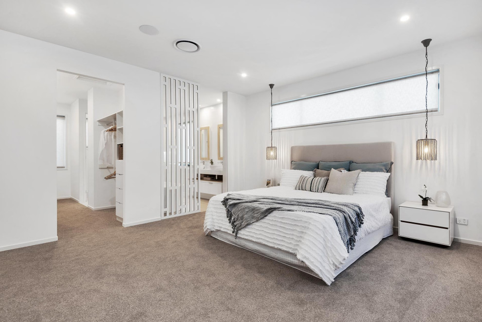 Large contemporary master bedroom in Brisbane with white walls, carpet and grey floor.
