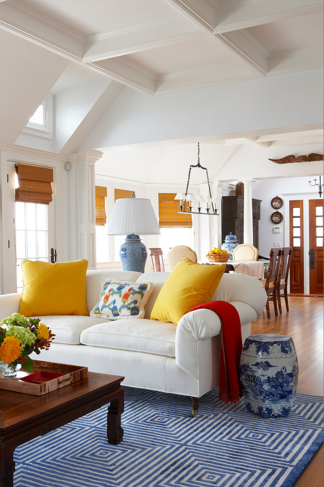 This is an example of a traditional living room in Miami with white walls and brown floor.