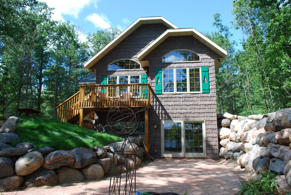 Design ideas for a mid-sized transitional partial sun front yard concrete paver retaining wall landscape for summer.