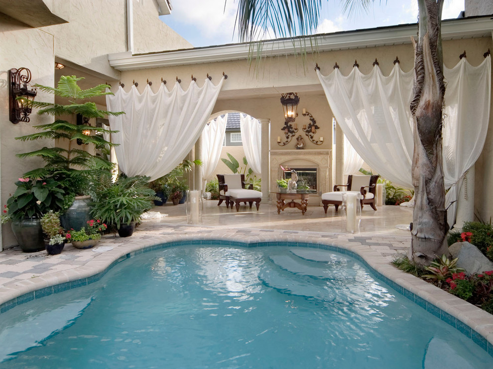 Inspiration for a tropical custom-shaped pool in Orlando.
